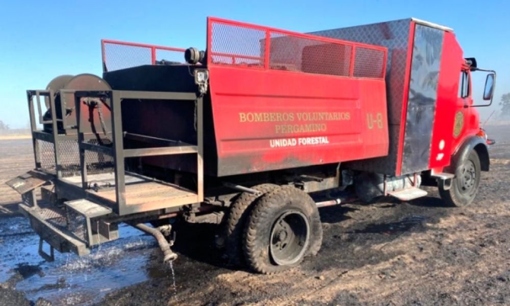 Autobomba destruido por las llamas en un campo
